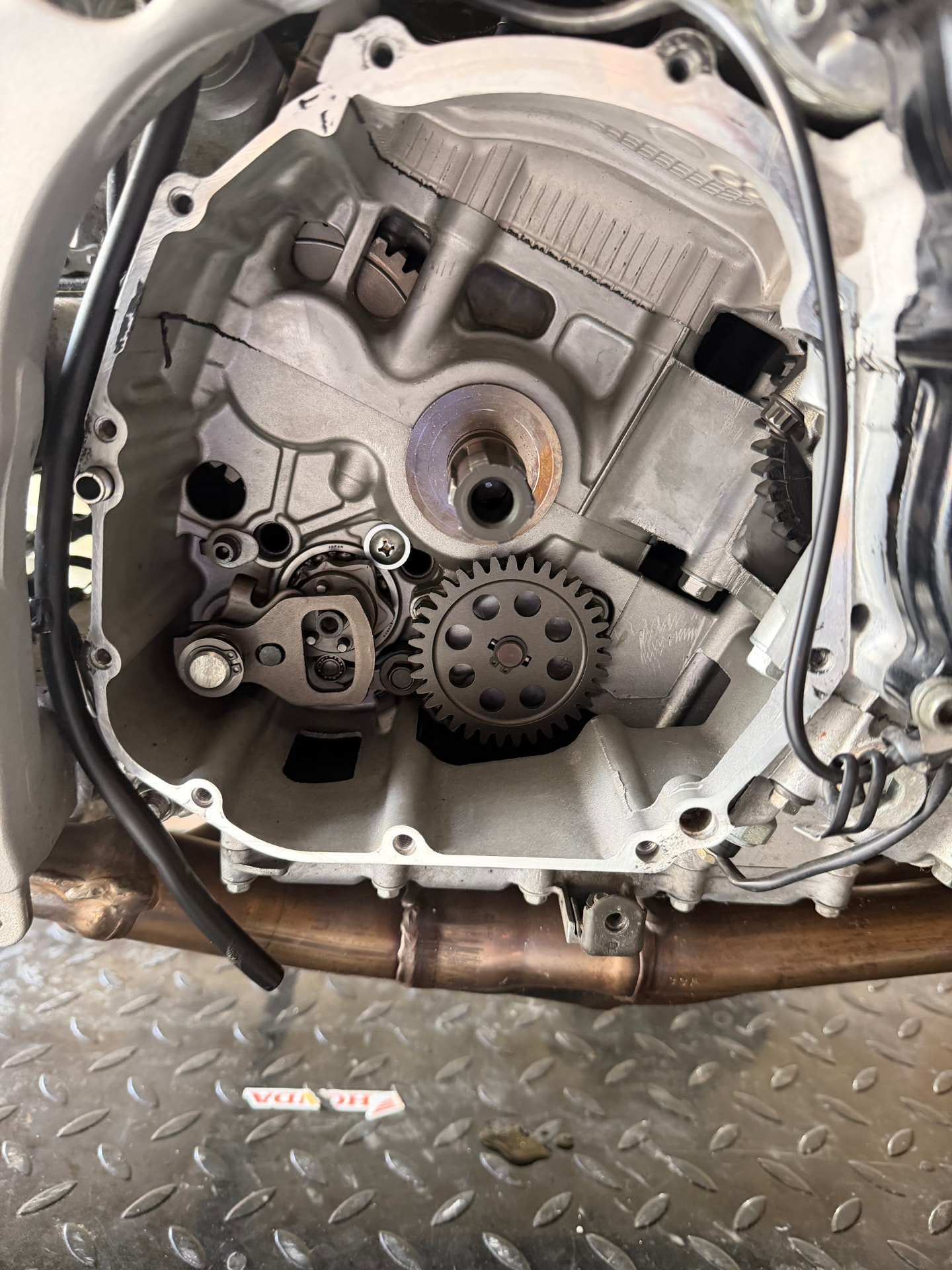 Motorcycle engine internals exposed during repair at 2WheeledMechanic
